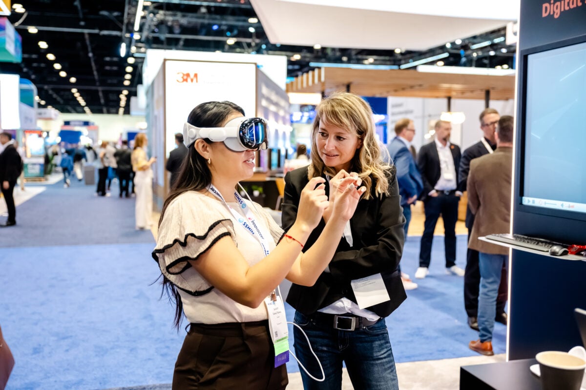 Healthcare professionals exploring AI solutions at the HIMSS25 AI Pavilion.
