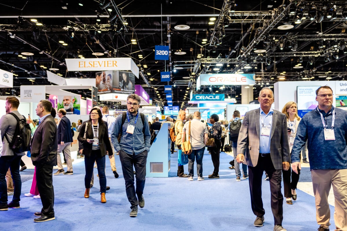 Healthcare professionals discussing 2025 go-to-market strategies at HIMSS conference