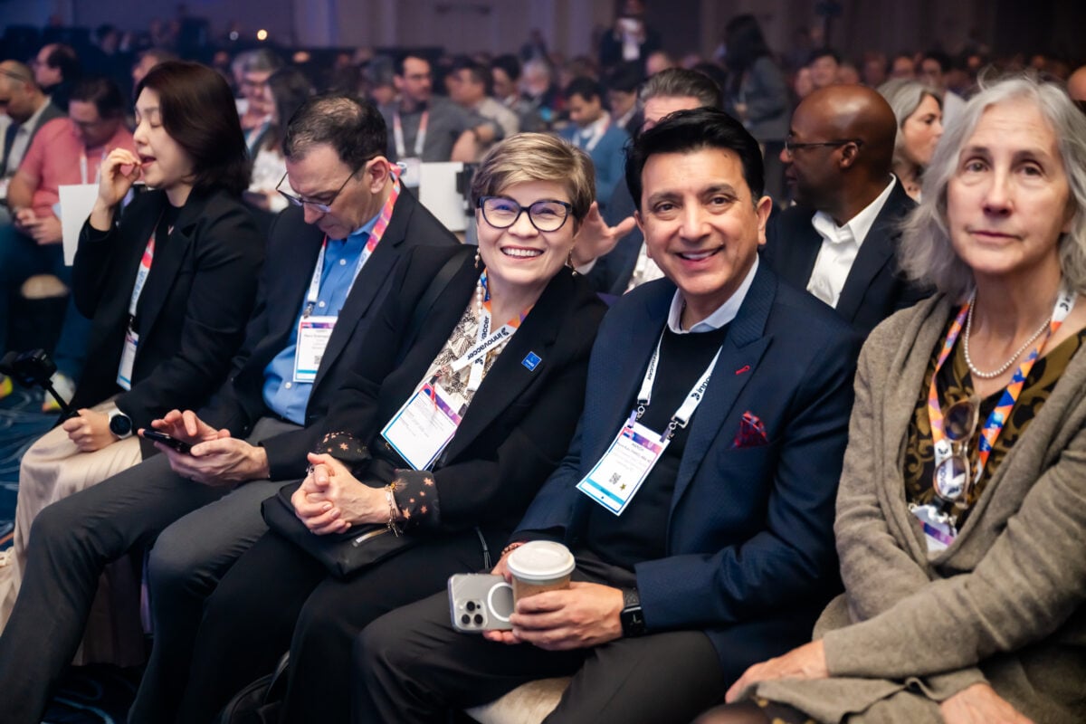 Gabriela Mustata Wilson (in the middle) at HIMSS25 with other attendees.